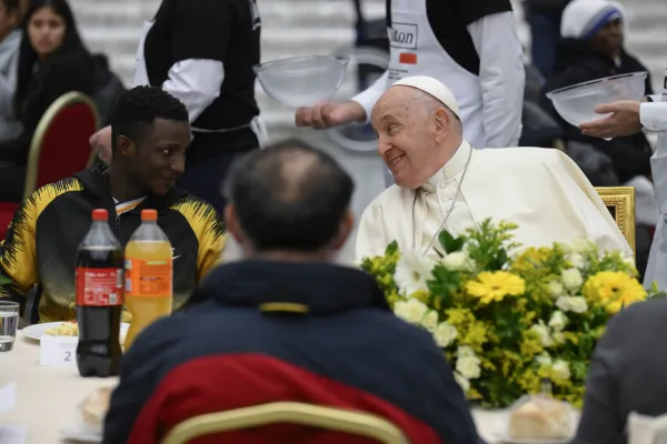 Pope Francis exchanges a look with someone seated at his table during a Vatican lunch with poor and economically disadvantaged people for the World Day of the Poor on Nov. 19, 2023. Credit: Vatican Media.