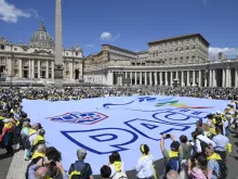 Members of ACLI (Italian Christian Workers' Associations) hold a sign with the word "peace" in Italian, in St. Peter's Square on June 1, 2024.