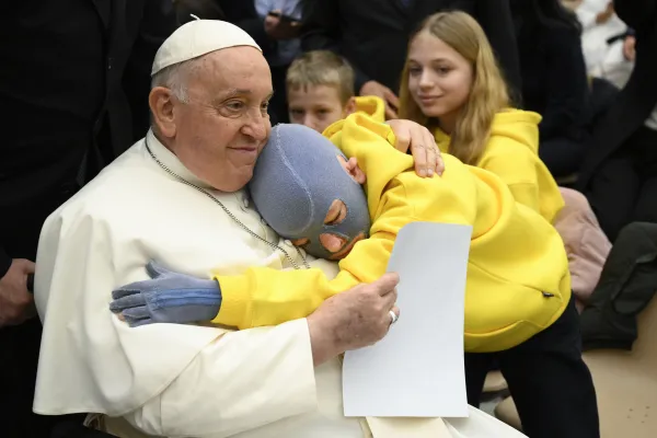 Pope Francis shares a hug with a young pilgrim at his general audience on Dec. 6, 2023, in Paul VI Hall at the Vatican. Credit: Vatican Media
