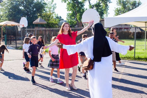 Third-grade classical teacher Kristin Yaneff greets Sister Francesca during a surprise visit at Lourdes Classical School in 2023. Credit: Photo courtesy of Our Lady of Lourdes Classical School