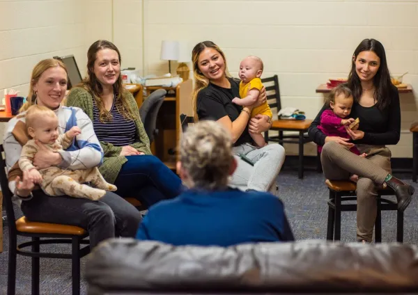 Katie Chihoski (on the right) with her baby, Lucia, and other moms with their children on the campus of University of Mary, which launched the Saint Teresa of Calcutta Community for Mothers in 2023 to help single mothers by providing room, board, and child care — as well semesterly retreats and frequent “community nights.” Credit: Photo courtesy of Katie Chihoski