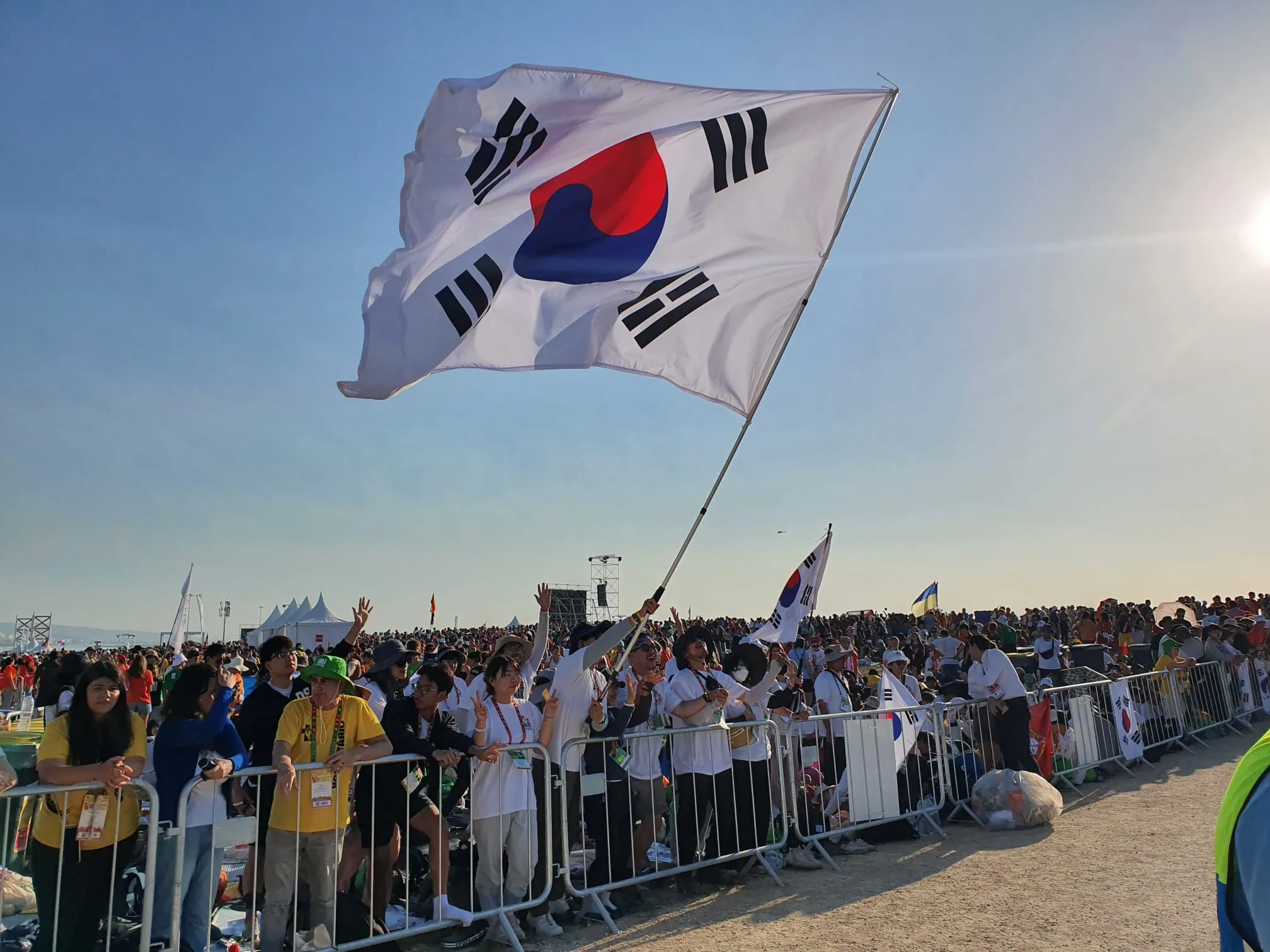 Pilgrims from South Korea wave a flag at Mass with Pope Francis for the closing of World Youth Day 2023 in Lisbon on Aug. 6, 2023.?w=200&h=150