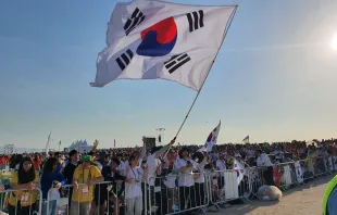 Pilgrims from South Korea wave a flag at Mass with Pope Francis for the closing of World Youth Day 2023 in Lisbon on Aug. 6, 2023. Hannah Brockhaus/CNA