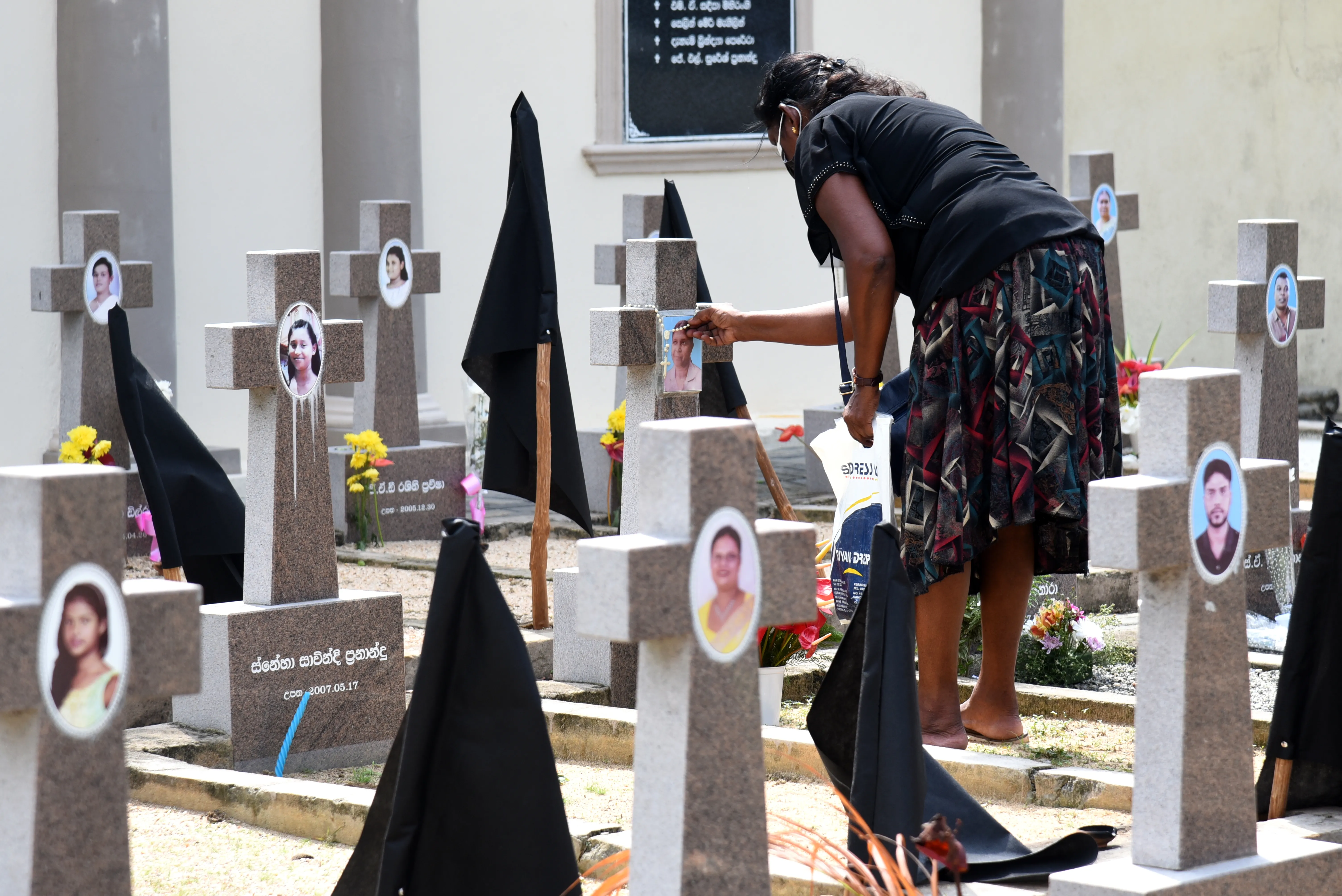 A woman was seen paying tribute to victims of the 2019 Easter Sunday terror attacks at a cemetery in Negombo, Sri Lanka.?w=200&h=150