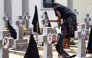 A woman was seen paying tribute to victims of the 2019 Easter Sunday terror attacks at a cemetery in Negombo, Sri Lanka. Credit: Shutterstock