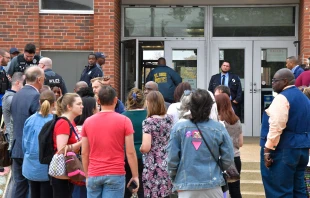St. Louis metropolitan police and school officials stand outside the south entrance to the Central Visual and Performing Arts High School after a shooting that left three people dead including the shooter in St Louis, Missouri on Oct. 24, 2022. Tim Vizer/AFP via Getty Images