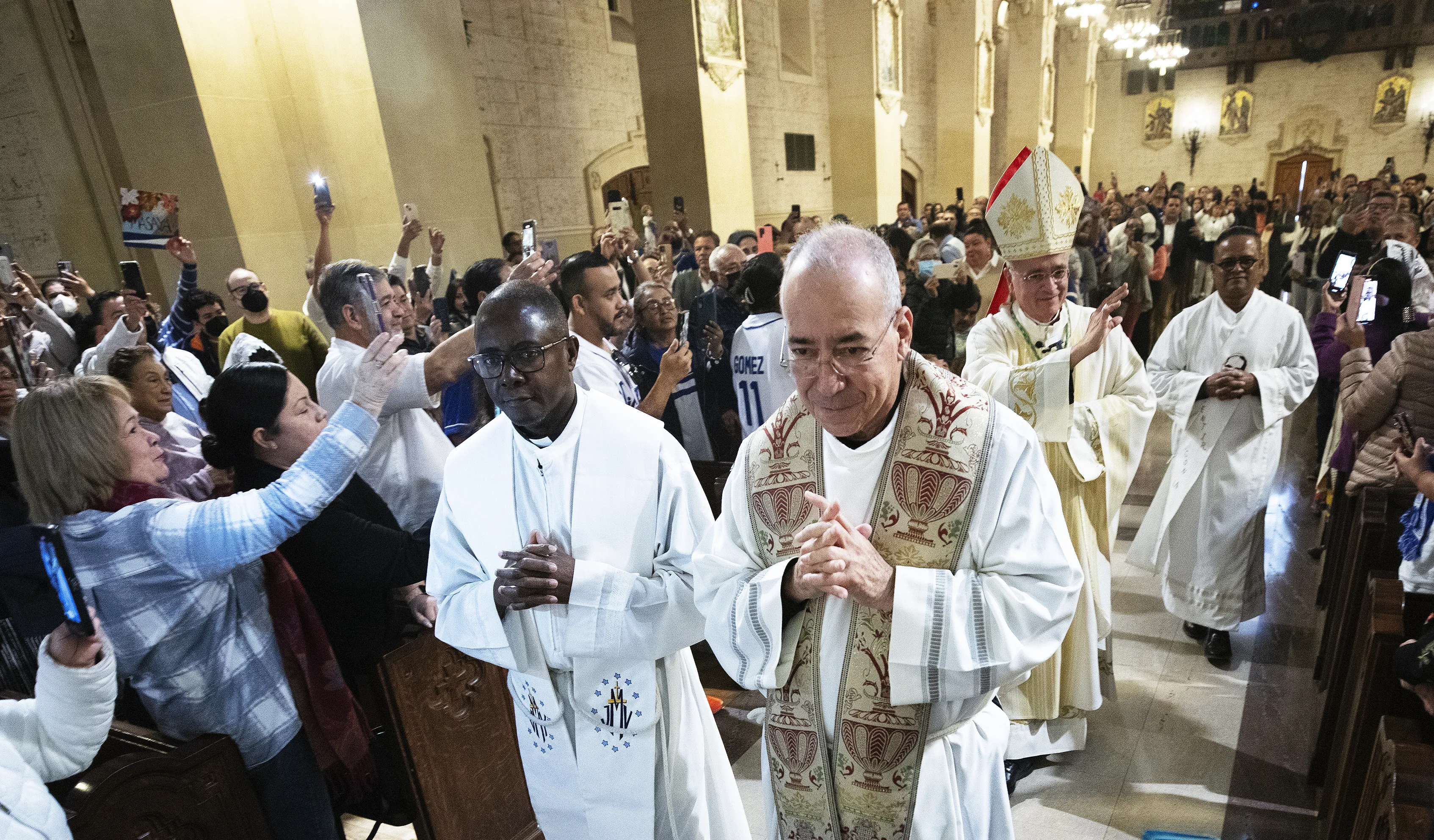 Auxiliary Bishop Silvio Báez, at right in the background, and Father Edwing Román, foreground center, both of the Archdiocese of Managua in Nicaragua, process into St. Vincent de Paul Church in Exposition Park in Los Angeles for Mass on Jan. 6, 2024.?w=200&h=150
