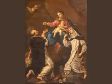 The Blessed Mother gives the rosary to St. Dominic in the 18th-century painting by Andrea Barbiani of the Madonna with St. Dominic and St. Catherine of Siena in the Basilica di Santa Maria del Porto in Ravenna, Italy.