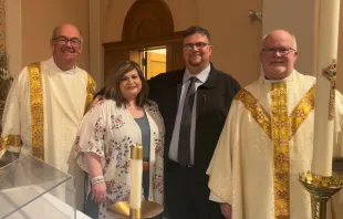 Recent convert Steve Dow and his wife, Amanda, pose for a photo with Deacon M.J. Kersenbrock, left, and Father Bernard Starman after the Easter Vigil April 16, 2022 at St. Patrick Church in O’Neill, Nebraska. Courtesy of the Dow family