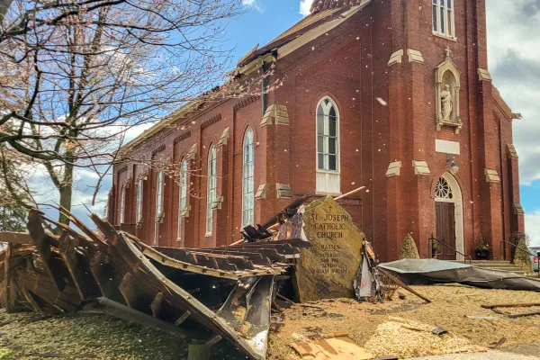 One of two large pieces of the roof from St. Joseph Church in Vanderburgh County landed adjacent to — but did not significantly damage — the stone marker in front of the church. Don Werner/The Message, Diocese of Evansville