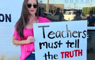 Jessica Tapia displays a sign outside the Garden Grove Unified School District board meeting on behalf of the Teachers Don’t Lie program. Credit: Photo courtesy of Advocates for Faith and Freedom and Jessica Tapia