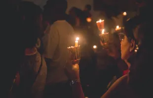 People holding candles. Thays Orrico via Unsplash.com.