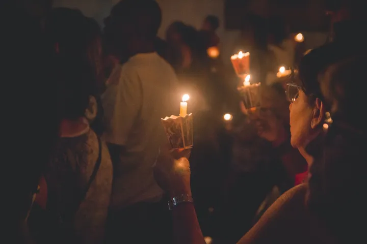 People holding candles.