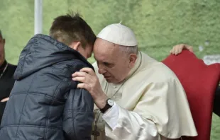 Pope Francis listens to a boy called Emanuele at St. Paul of the Cross parish, Rome, on April 15, 2018. Vatican Media.