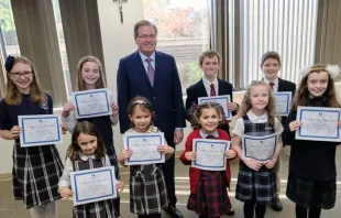 Students who are all winners of the St. Joseph art contest stand alongside Thomas Carroll, superintendent of schools for the Archdiocese of Boston. Credit: Archdiocese of Boston