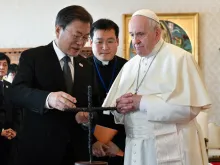 South Korean President Moon Jae-in presents the cross to Pope Francis at the Vatican, Oct. 29, 2021.