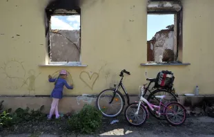 A young girl draws on the wall of a destroyed house in the village of Andriivka, Kyiv region, on June 3, 2022 on the 100th day of the Russian invasion of Ukraine. Sergei Chuzavkov/AFP via Getty Images) Sergei Chuzavkov/AFP via Getty Images