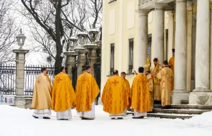 Greek-Catholic priests in phelonia in front of a church in Lviv, Ukraine, in 2018. Shutterstock