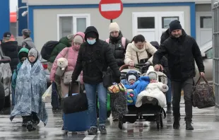 Ukrainian refugees walk from Ukraine to Isaccea in Romania after crossing the border on March 2, 2022. Shutterstock