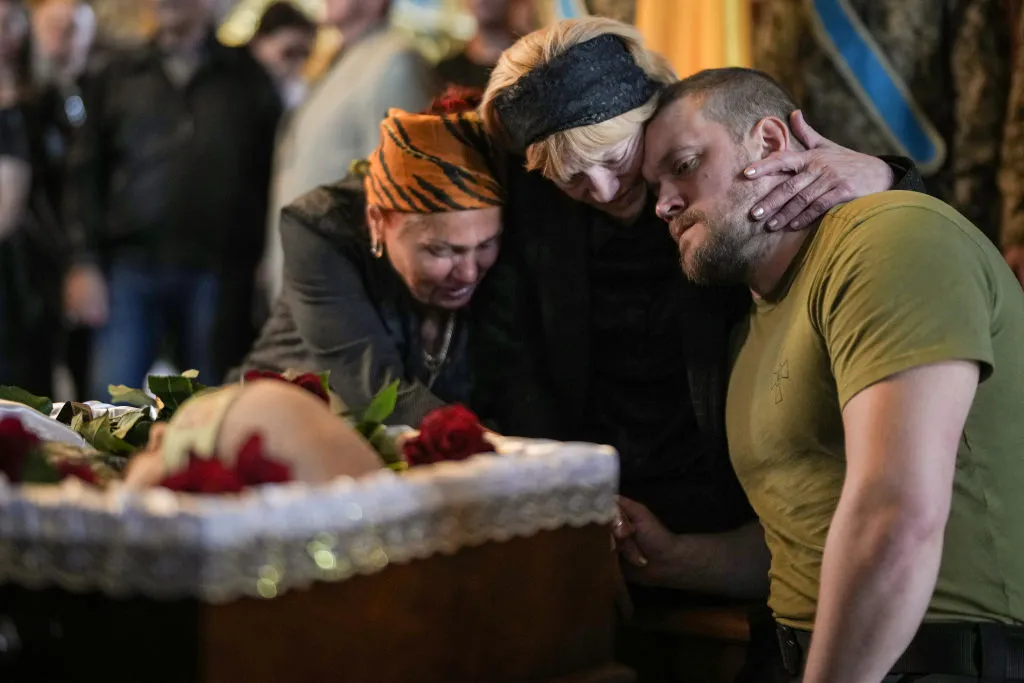 Relatives, friends and comrades of Ukrainian soldier Eduardo Trepilchenko, who was killed on the Eastern front battling the Russian invasion , attend his funeral at St Michael's Cathedral on May 25, 2022 in Kyiv, Ukraine.?w=200&h=150