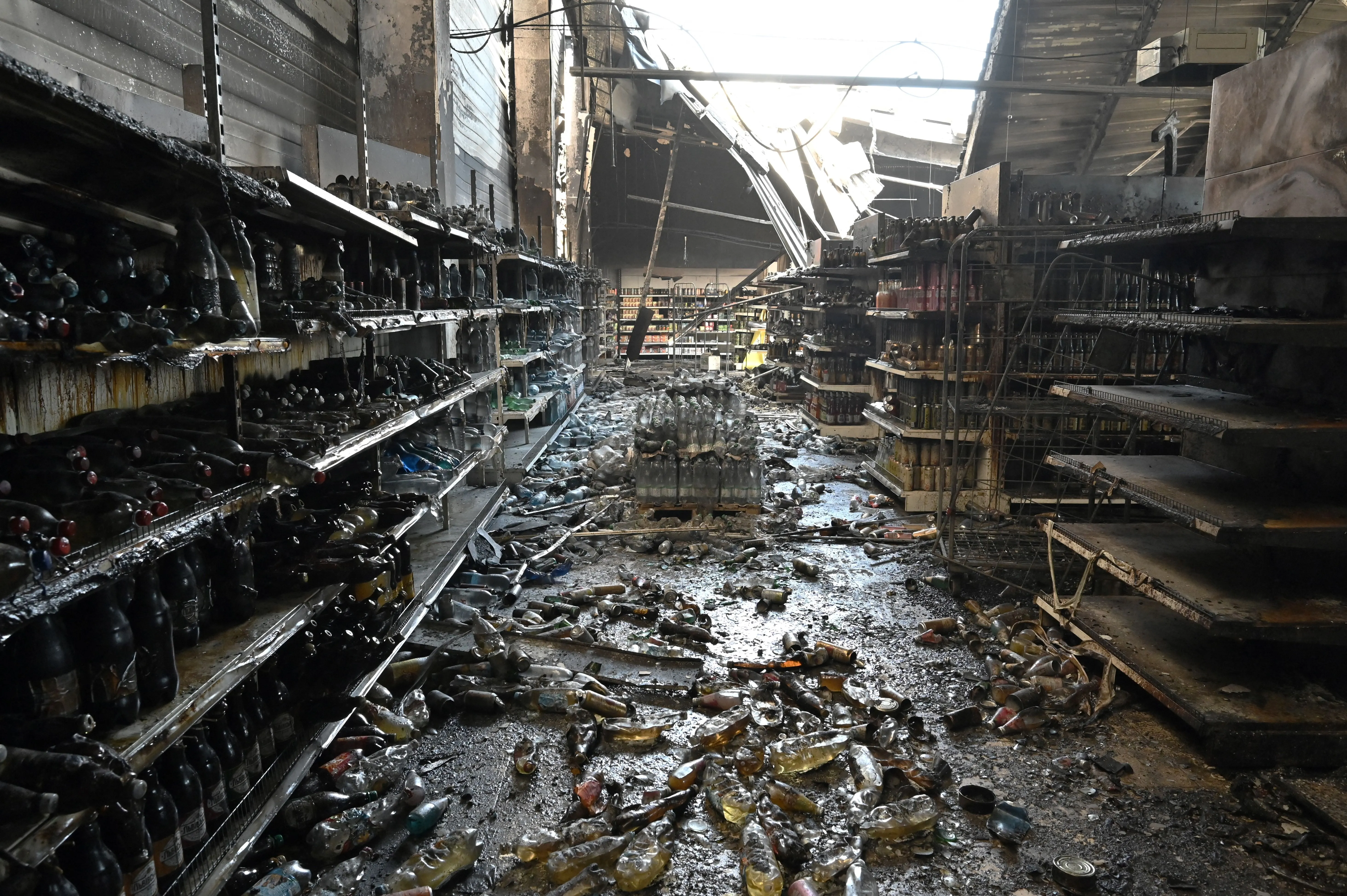 A photograph taken on June 28, 2022 shows charred goods in a grocery store of the destroyed Amstor mall in Kremenchuk, one day after it was hit by a Russian missile strike according to Ukrainian authorities.?w=200&h=150