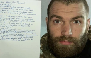 Major Serhiy Volyna, who has been leading the 36th marine brigade in the battle for the Ukrainian port city of Mariupol, pictured holding his letter to Pope Francis. Religious Information Service of Ukraine