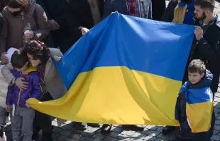 People raise the Ukrainian flag at Pope Francis' Angelus address at the Vatican, March 6, 2022. Vatican Media.