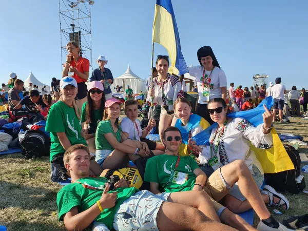 Marina Aleykseyeva, 31, from Kiev, Ukraine, (second from left with a pink baseball cap), together with fellow pilgrims from Ukraine, attended World Youth Day in Lisbon, Portugal. She said they traveled to the international gathering to pray for peace in their country. Hannah Brockhaus/CNA