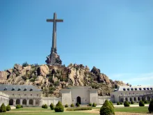 A monumental cross towers above the Valley of the Fallen complex.