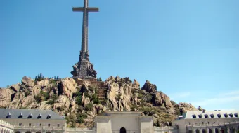 A monumental cross towers above the Valley of the Fallen complex.