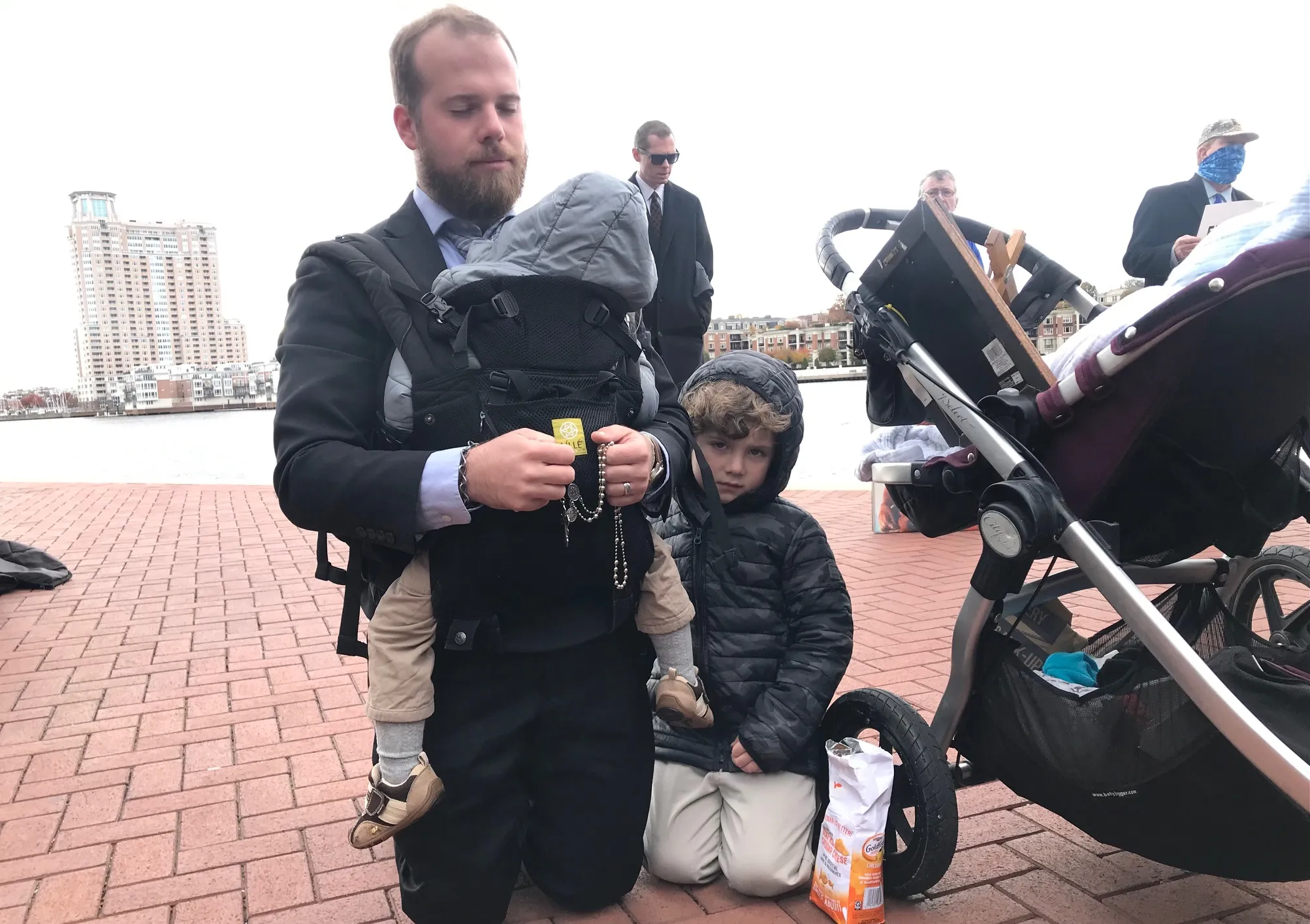 Gabriel Vance, of Columbus, Ohio, prays the rosary, with his three young sons beside him, at the pro-life Men's March in Baltimore on Nov. 15, 2021.?w=200&h=150