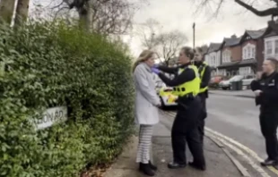 A pro-life woman is arrested for praying silently in alleged violation of a local buffer zone law. ADF-UK