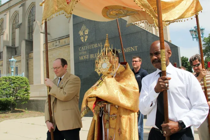 Archbishop Allen H. Vigneron carries the Blessed Sacrament in procession during the feast of Corpus Christi in June 2016.