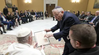 Pope Francis receives a facsimile of a 1919 letter by Adolf Hitler for the Vatican archives during an audience with a delegation of Simon Wiesenthal Center at the Vatican, June 22, 2022.