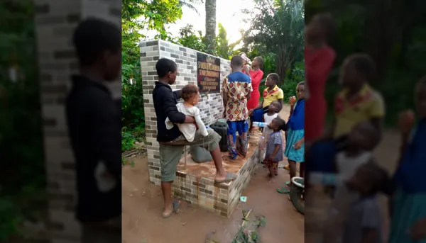 Some children in the village of Ozuomme, Nigeria can be seen benefitting from a well built with the funds raised by young adults at St. Mary's Catholic Church in Dedham, Massachusetts. Tutus Yilaih