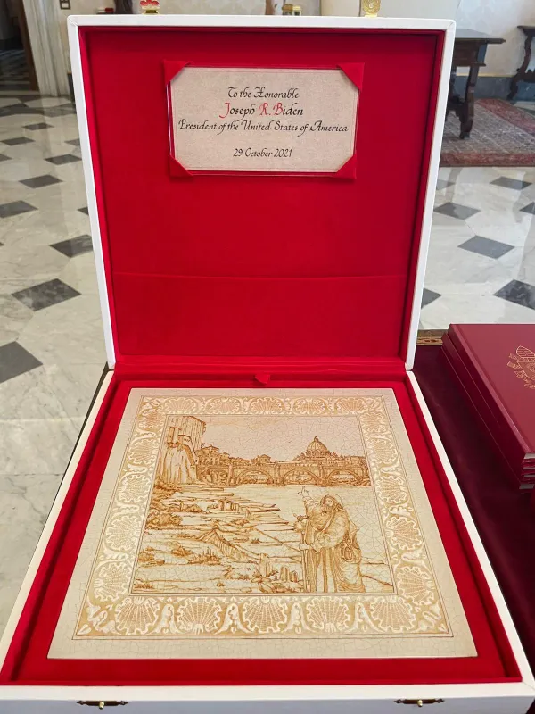 Pope Francis' gift to President Joe Biden was a ceramic tile with an image of a pilgrim journeying to St. Peter's Basilica. Holy See Press Office