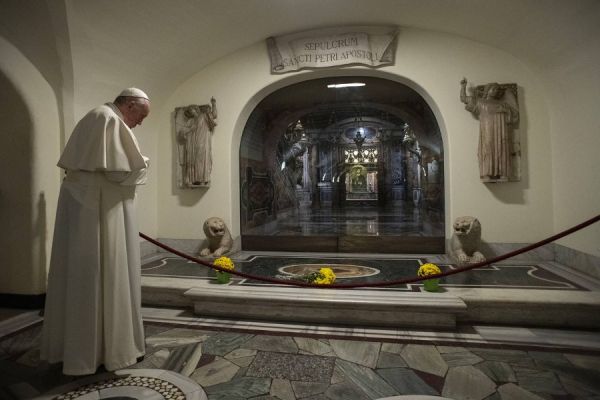 Pope Francis prays at the Confessio, the place where St. Peter's bones are buried in the crypt beneath St. Peter’s Basilica, Nov. 2, 2021. Vatican Media.
