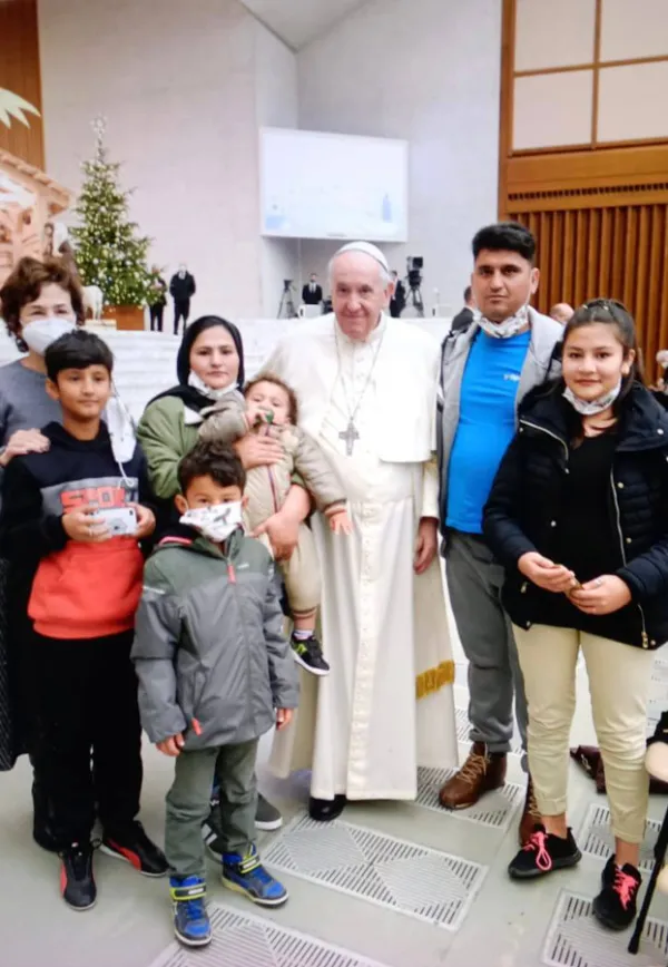 Pope Francis greets a family from the Mavrovouni refugee camp in Lesbos, Greece, after his general audience in the Paul VI Hall, Dec. 22, 2021. Vatican Media.