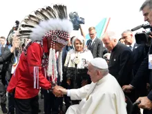 Pope Francis is greeted by a representative of Canada's indigenous peoples upon his arrival in Edmonton, Alberta, on July 24, 2022 at the start of his six-day visit to Canada.
