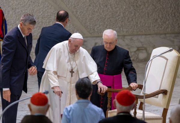 Pope Francis moving from his wheelchair to his seat at the general audience, Aug. 24, 2022. Pablo Esparza / CNA