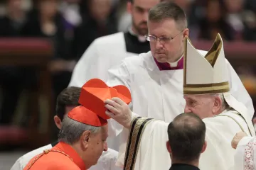 Cardinal Oscar Cantoni, bishop of Como, receives the red biretta from Pope Francis at the consistory in St. Peter's Basilica, Aug. 27, 2022.