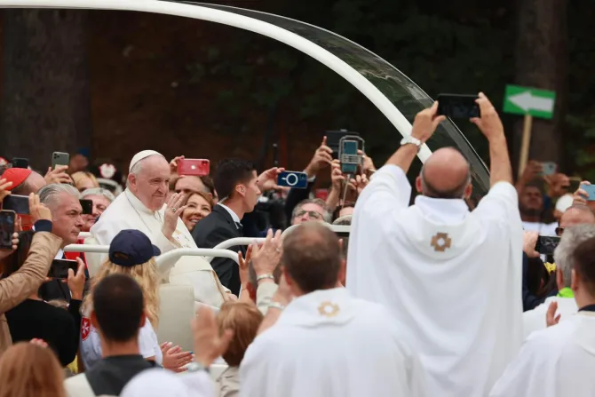 Pope Francis greets the crowd from the popemobile in L'Aquila, Italy on Aug. 28, 2022.