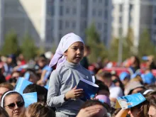 A young girl at a large outdoor Mass celebrated by Pope Francis in Kazakhstan’s capital of Nur-Sultan on Sept. 14, 2022.