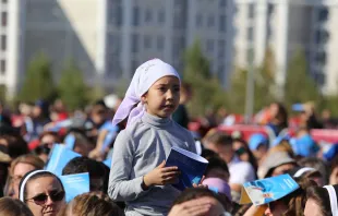 A young girl at a large outdoor Mass celebrated by Pope Francis in Kazakhstan’s capital of Nur-Sultan on Sept. 14, 2022. Vatican Media