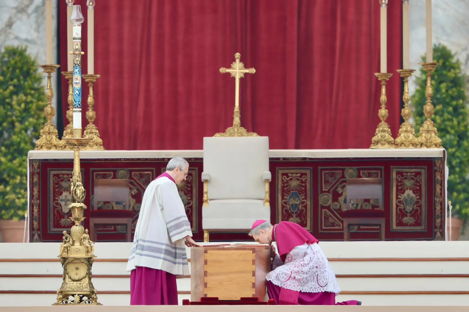 Archbishop Georg Gänswein (right), the longtime personal secretary for Benedict XVI,  kneels to kiss the book of the Gospels atop the coffin of the pope emeritus on Jan. 5, 2023, in St. Peter's Square?w=200&h=150