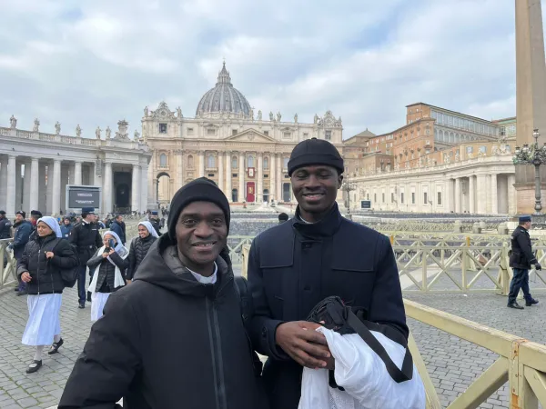 Father Anthony Agnes Adu Mensah from Accra, Ghana (left) with a seminarian from his diocese attend the funeral of Pope Benedict XVI on Jan. 5, 2023, in St. Peter's Square at the Vatican. Courtney Mares / CNA