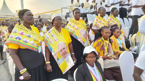 During the Mass, dancers wearing bright yellow sashes adorned with a large photo of Pope Francis and photos of other clergy danced in the field below the altar. Elias Turk/EWTN