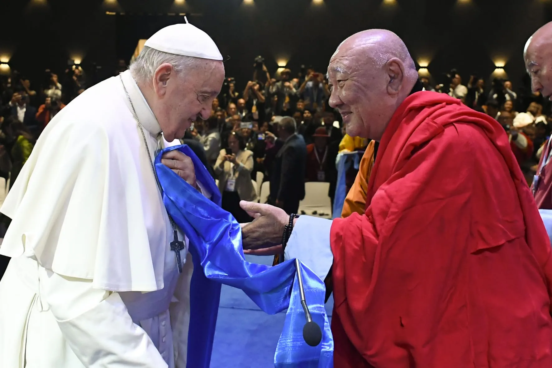 Khamba Nomun Khan, the head of the Gandan Monastery in Ulaanbaatar, accompanied Pope Francis as he made his entrance at the interreligious dialogue event at the Hun Theater in Mongolia on Sept. 3, 2023.?w=200&h=150