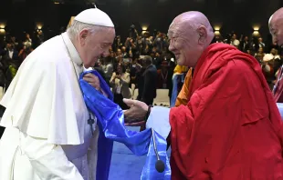Khamba Nomun Khan, the head of the Gandan Monastery in Ulaanbaatar, accompanied Pope Francis as he made his entrance at the interreligious dialogue event at the Hun Theater in Mongolia on Sept. 3, 2023. Vatican Media