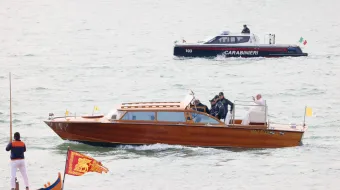 Pope Francis waves while traveling by boat in Venice, Italy, for a meeting with young people at the Basilica della Madonna della Salute on April 28, 2024. Earlier in the day he met with inmates at a women's prison.